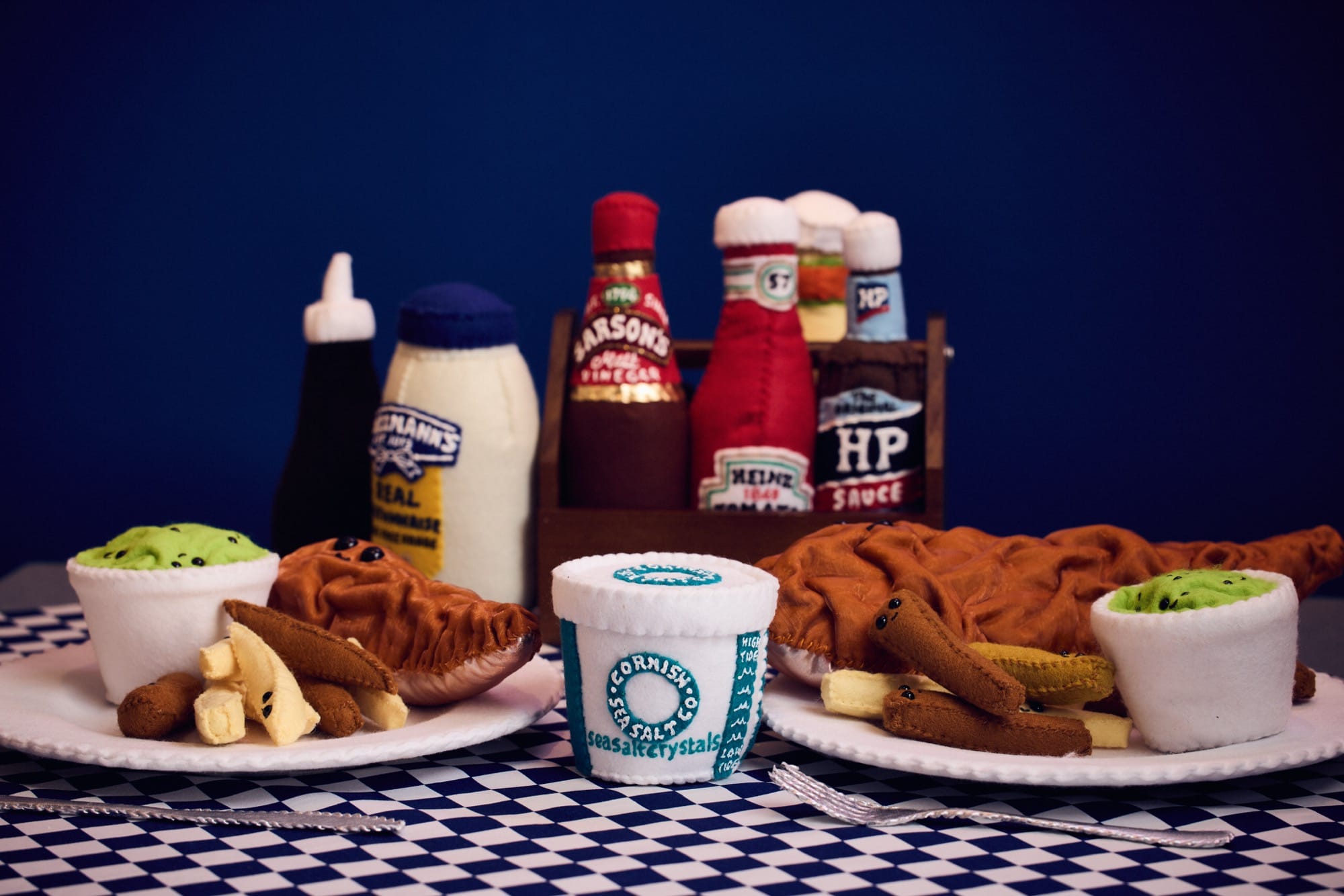 fish and chips, HP sauce, malt vinegar, and other condiments in an art installation made entirely of felt