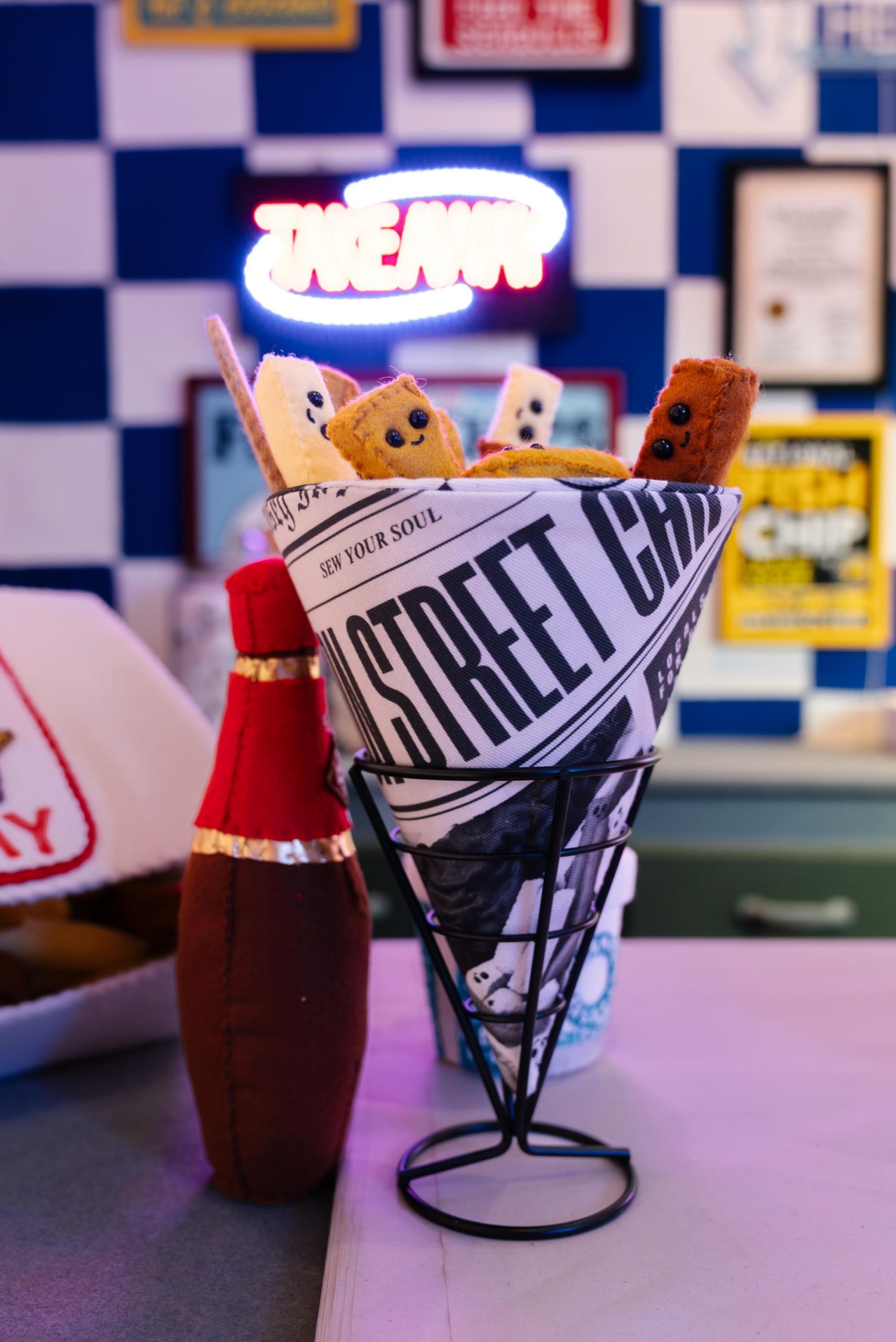 a newsprint cone full of chips in an art installation made entirely of felt