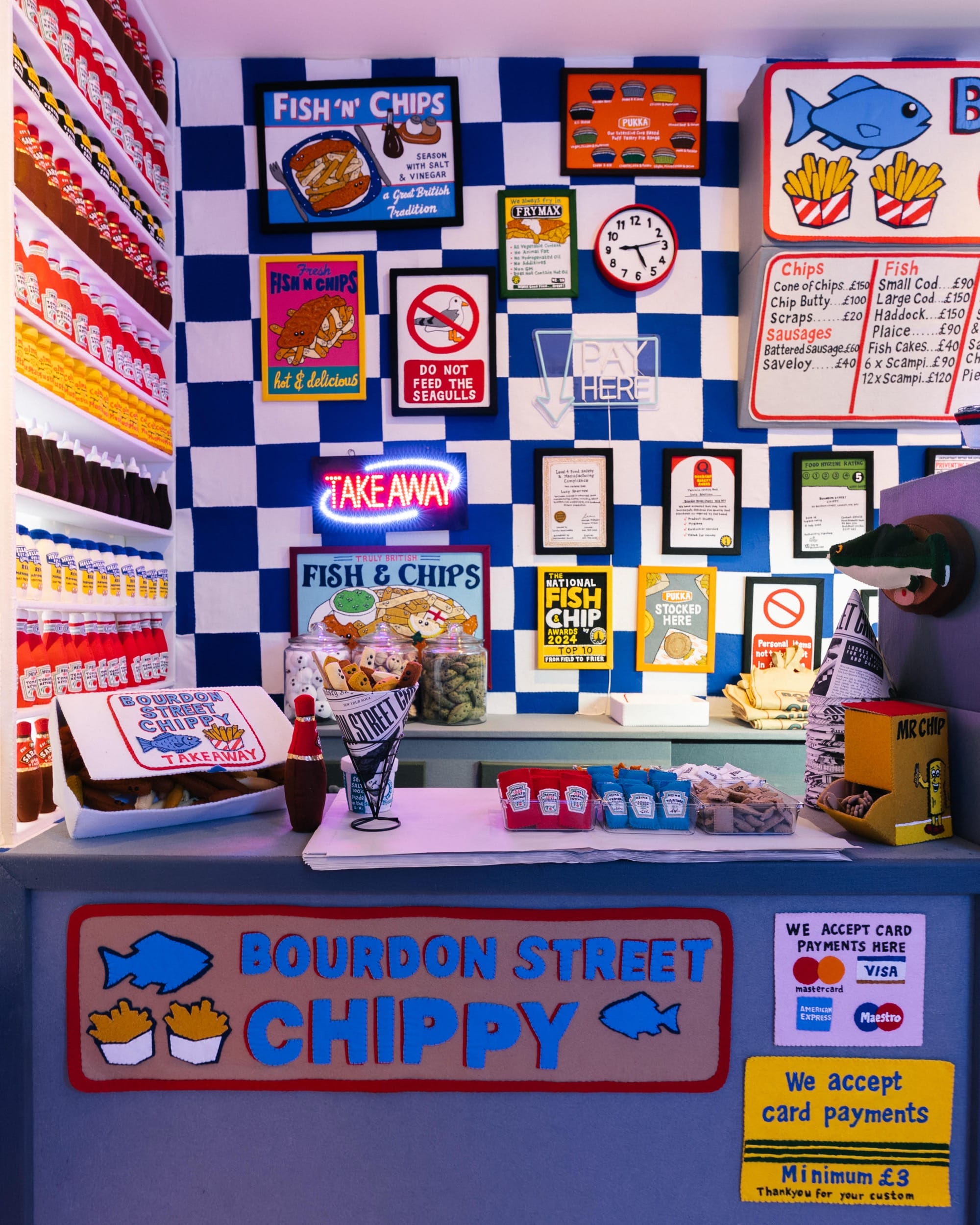 the interior of an art installation of a fish and chip shop made entirely of felt